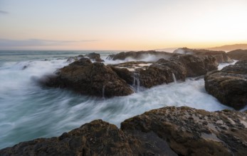 Waves washing over rocks by the sea, long exposure, coastal landscape at sunset, Playa Cocalito,