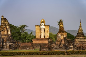 Giant standing Buddha in the Wat Mahathat temple in the UNESCO World Heritage Sukhothai Historical