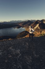 Trail running in autumn on the Jochberg on Lake Walchensee against the wonderful backdrop of the