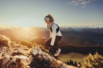 Trail running in autumn on the Jochberg on Lake Walchensee against the wonderful backdrop of the