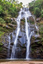 Waterfall inside the rainforest surrounded by rocks and vegetation in Minas Gerais, Brazil Brazil