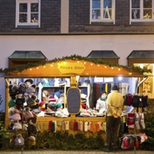 Nostalgic Christmas market on the church square in front of half-timbered houses in the evening,