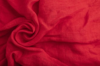 Fragment of red silk tissue. Top view, flat lay, natural textile background and texture. wave