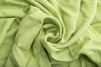 Fragment of green linen tissue. Side view, natural textile background and texture. wave concept,