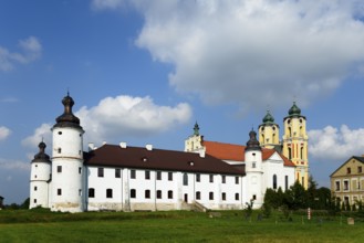 Dominican monastery with white walls and baroque towers under a cloudy sky, Sejny, Podlaskie,