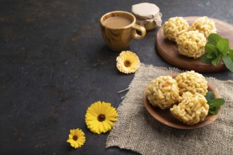 Traditional Tatar candy chak-chak made of dough and honey with cup of coffee on a black concrete