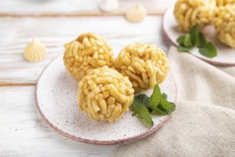 Traditional Tatar candy chak-chak made of dough and honey with cup of coffee on a white wooden