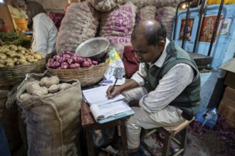 Vendor selling vegetables at a market, ahead of the presentation of the Interim Budget 2024 by