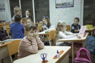 Pupils in a classroom in one of the metro schools in Kharkiv. Classrooms were set up in various