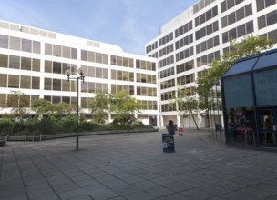 Modern architecture people walking between insurance company offices in the Tricentre development