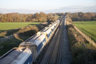 Open waggons of freight train on the West Coast mainline at Woodborough, Wiltshire, England, UK