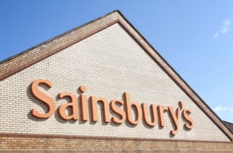 Close up of Sainsbury's supermarket store sign, Chippenham, Wiltshire, England, UK