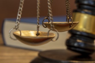 Book and judge's gavel as a symbolic image for a court judgement