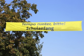 Tension tape over the road with a sign for school starters