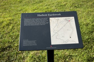 English Heritage information board for the Neolithic Hatfield earthwork site at Marden, Wiltshire,