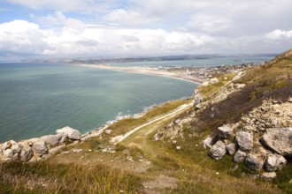 Chiswell village at the start of Chesil Beach with Weymouth harbour beyond, Isle of Portland,