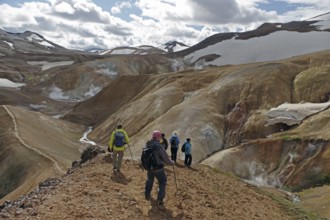 Hikers travelling in a desert-like, geothermally active mountain region, fire and ice,