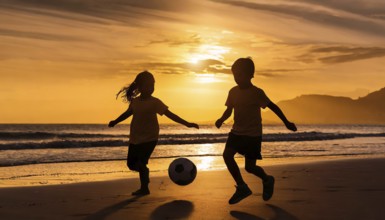 Active children playing soccer football on a beach. Brother and sister, family sport fun, AI