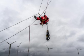 Height rescuers from the Oberhausen fire brigade practise abseiling from a wind turbine from a