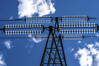 Insulators made of glass on a high-voltage line, they hang on the pylons as a suspension device