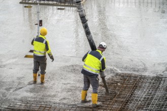 Construction site, concreting, floor, ceiling for a building is concreted, the concrete is pumped