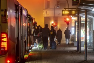 Bus stop, in the fog, passengers boarding a bus, autumn, winter, Essen, North Rhine-Westphalia,