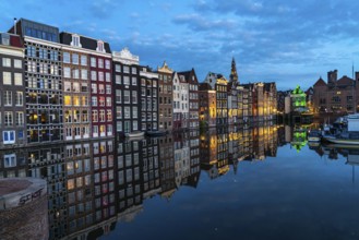 Canal houses on the Damrak, in the centre of the old town of Amsterdam, harbour, starting point of