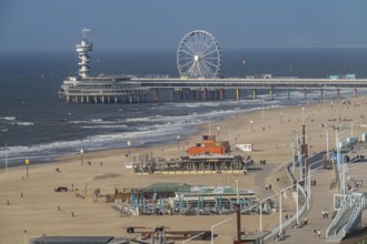 View over the beach of Scheveningen, the pier with Ferris wheel belongs to the city of The Hague