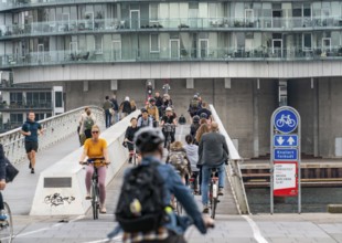 Cyclists on the Bryggebroen cycle and footpath bridge over the harbour, Sydhavnen, Copenhagen is