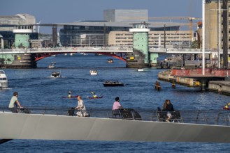 Cyclists on the Lille Langebro cycle and pedestrian bridge over the harbour, Copenhagen is