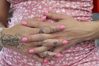 Hands of a young woman with painted nails and tattoos on her fingers, Bavaria, Germany, Europe