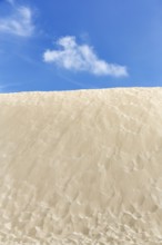 Empty dune, shifting dune, fine sand, spring clouds, minimalist landscape, symbolic image,