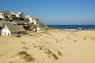 Colourful holiday homes and beach, Monte Clérigo, Atlantic coast, Algarve, Portugal, Europe