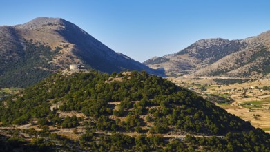 Askifou Fortress, Sun-drenched mountains and valleys with an ancient ruin and blue sky, Askifou