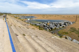 Shingle beach and lagoons in front of coastal defences near Felixstowe Ferry, Suffolk, England, UK