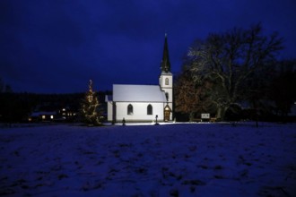 A Christmas tree stands in front of the smallest wooden church in Germany, Elend, 29 December 2020