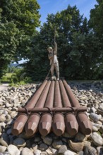 Sculpture of a raftsman at the rafting museum, transport museum, sight in the old town centre of