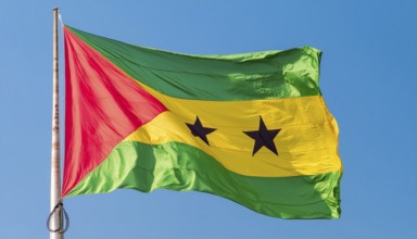 The flag of the Democratic Republic of Sao Tome, Africa, flutters in the wind, isolated against a