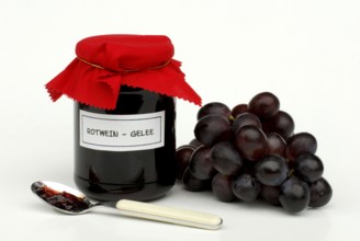 Red wine jelly in glass and grapes, red wine jelly, spoon