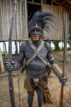 Chief of the village Mutin with bow and arrow, Lake Murray, Western Province, Papua New Guinea,