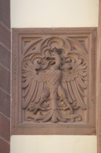 Stone eagle as state coat of arms and city coat of arms, federal eagle, red, city hall courtyard,