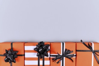 Orange Halloween gift boxes on gray background