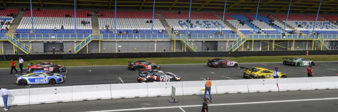 Panoramic photo of part of grid lane with starting grid of racing cars sports cars of GT4 class of