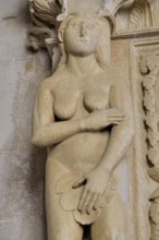 Eve with a fig leaf on the western gate of Trogir Cathedral or Cathedral of St. Lawrence, 13th