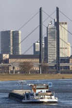 Düsseldorf, city centre skyline, skyscrapers, Rheinkniebrücke, Rhine, cargo ship