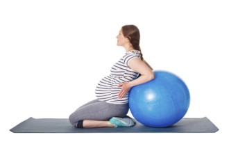 Pregnancy exercise concept, pregnant woman doing exercises with exercise ball isolated on white