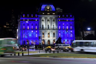 Traffic in front of the Centro Cultural Kirchner, Kirchner Cultural Center, illuminated at night in