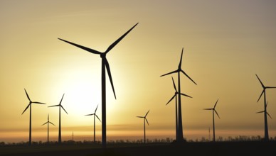 Eco-friendly wind turbine at sunrise in Saxony, Germany, Europe