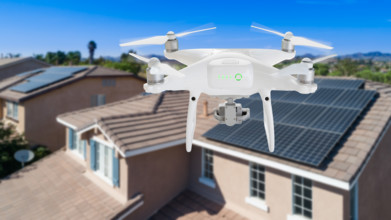 UAV drone inspecting solar panels on large house