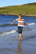 Boy on the beach, Sutherland, Scotland, Great Britain